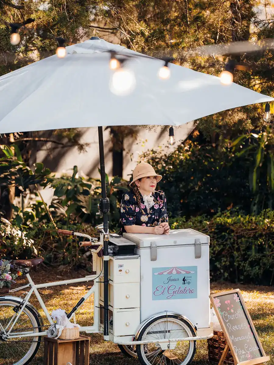 Carrito de helados vintage bajo una sombrilla, en los jardines de Laureal